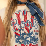 Person wearing a sleeveless top with 'Boots on the Ground' graphic design.