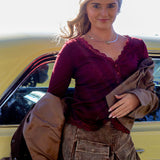 Woman standing next to a yellow car holding a brown jacket