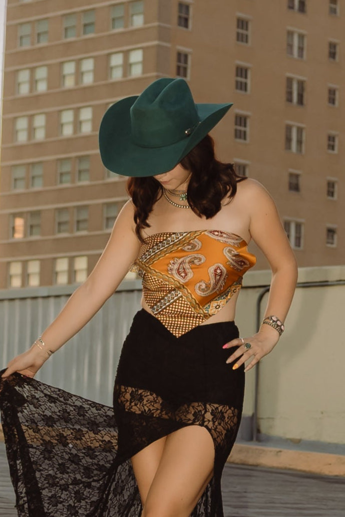 Woman on a rooftop with a tall building featuring 'ALICO' in the background