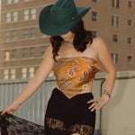 Woman on a rooftop with a tall building featuring 'ALICO' in the background
