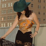 Woman on a rooftop with a tall building featuring 'ALICO' in the background
