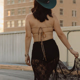 Woman on a rooftop with a building featuring 'ALICO' in the background